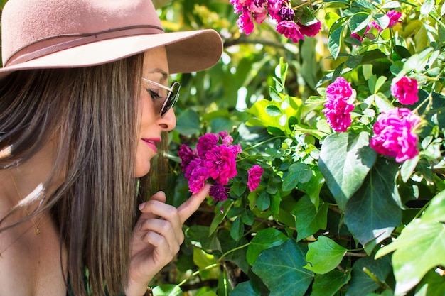 Close-up Of A Beautiful Young Woman Smelling A Flower In Spring.
