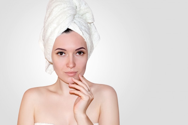 Close Up Beautiful Young Woman in White Towel on Head After Shower. Spa Concept