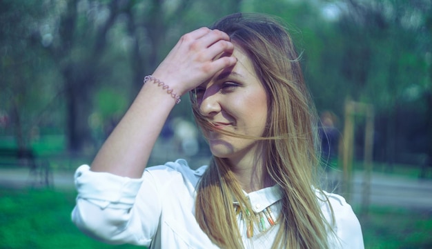 close-up of beautiful young woman with hand in hair