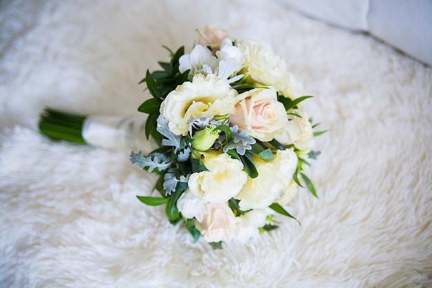 Close-up of beautifully arranged wedding bouquet on sofa