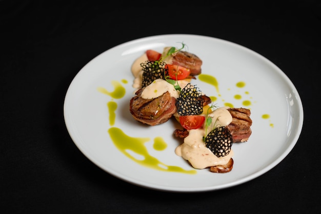 Close up, beautifully decorated meat in a white plate