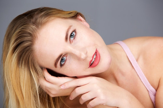 Close up beauty portrait of young blond woman staring