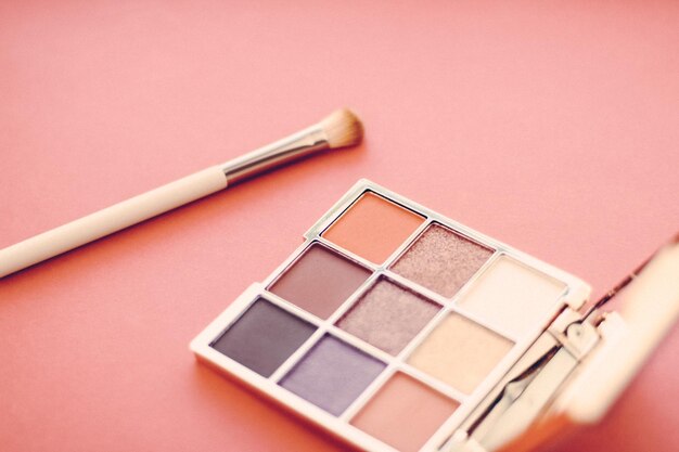 Close-up of beauty products against pink background