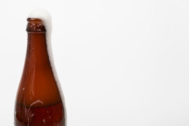 Photo close up beer bottle and foam with copy space