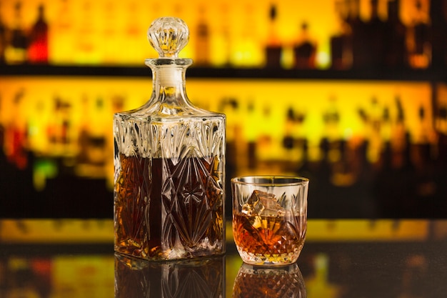 Close-up of beer bottle and glass in bar