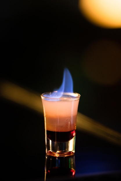 Close-up of beer glass against black background