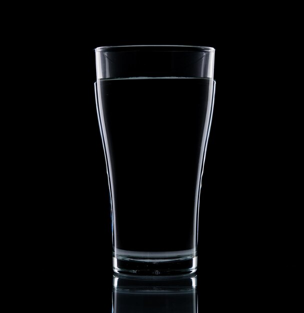 Close-up of beer glass against black background