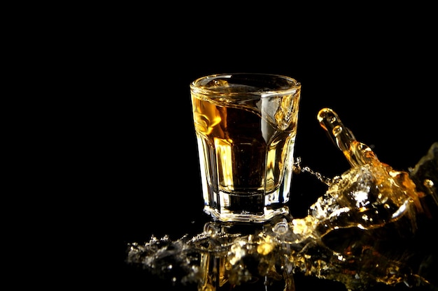 Close-up of beer glass against black background