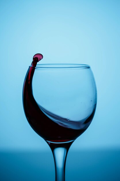 Close-up of beer glass against blue background