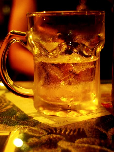 Close-up of beer glass on table