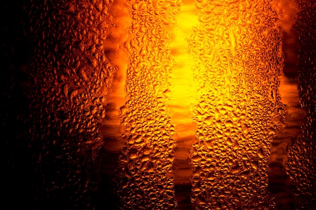 Close up of the beerClose up in foam and bubbles of beer on black backgroundWater drops background