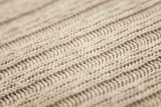 Close up of beige knitted textured background