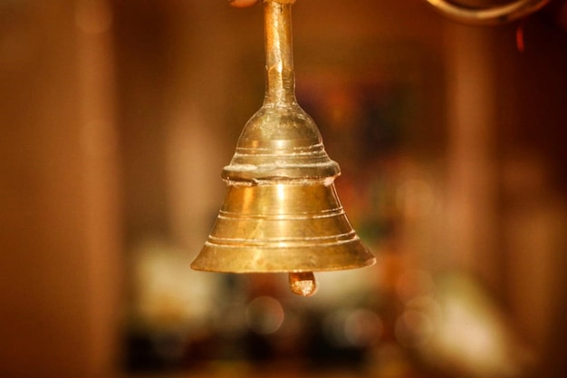 Photo close-up of bell hanging against blurred background