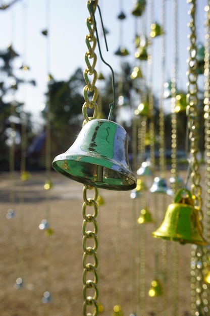 Photo close-up of bells hanging outdoors