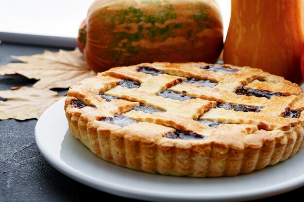 Close up of a berry tart pie served on wooden table