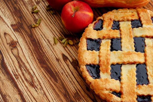 Close up of a berry tart pie served on wooden table