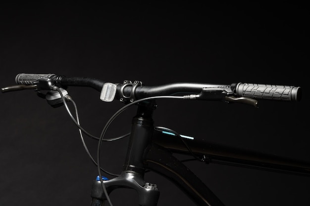 Close up of a bicycle against black background