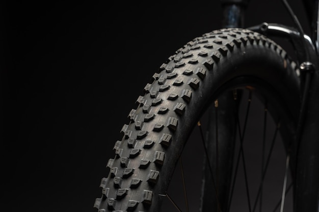 Close up of a bicycle against black background