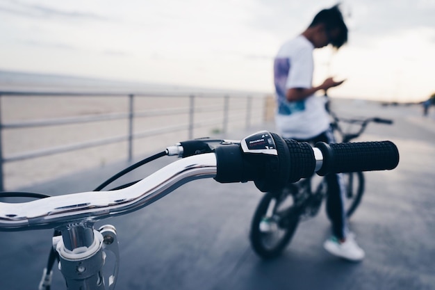 close-up of bicycle by man on pier