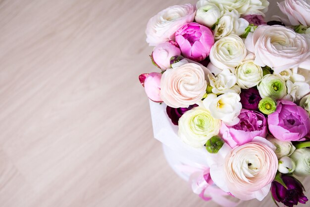 Close up of big bouquet of summer flowers over wooden background