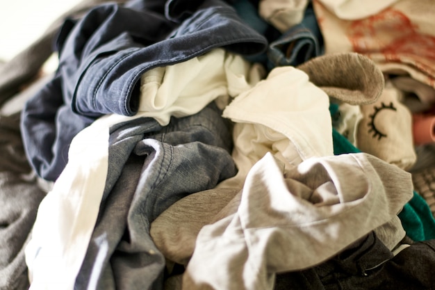 Close up on a big pile of clothes and accessories thrown on the ground