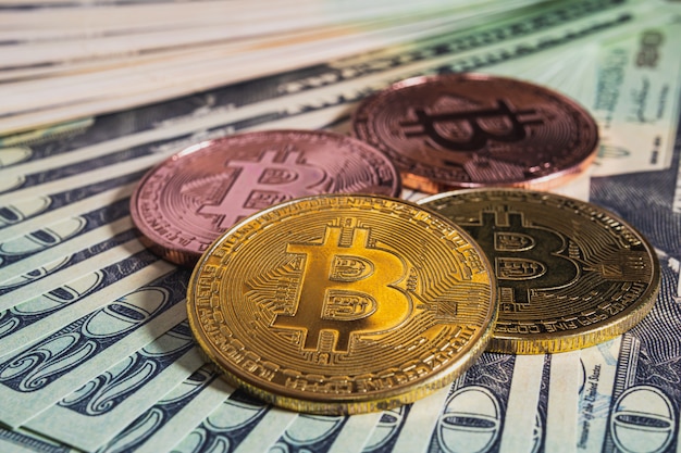 close up of bitcoin and bank notes on the table