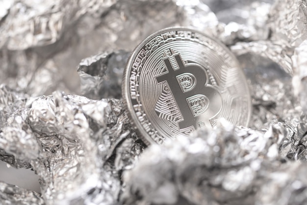 Photo close-up of bitcoin on the foil surface