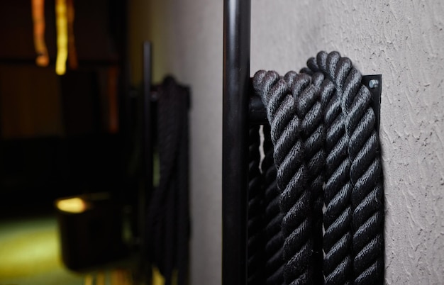 Close up of black battle rope on a gray backgound sport and fitness equipment functional training