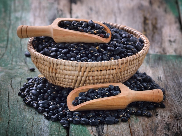 Photo close-up of black beans in basket on table