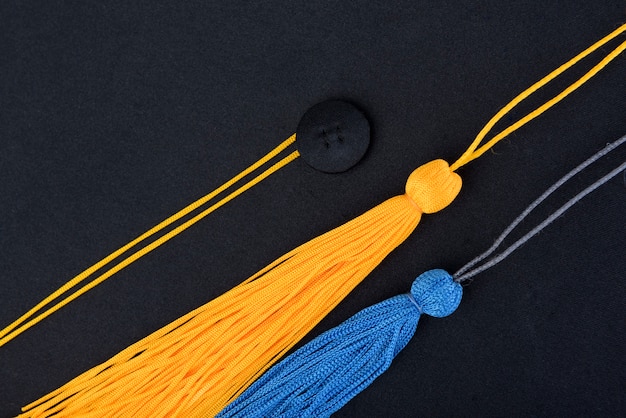 close-up Black Graduation Cap And yellow,blue tassel