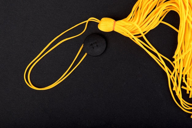 close-up Black Graduation Cap And yellow tassel