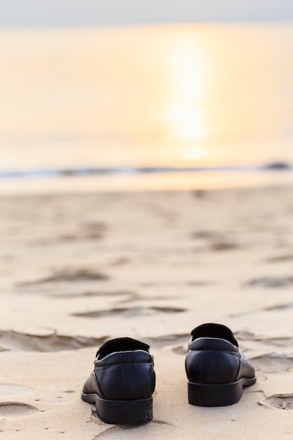 Close up black man leather shoe on the beach