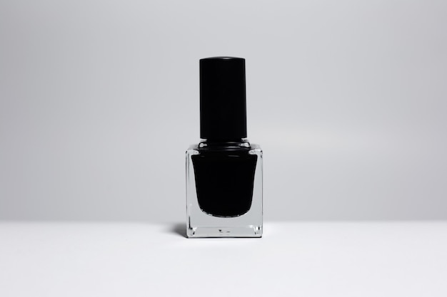 Close-up of black nail polish isolated on white surface