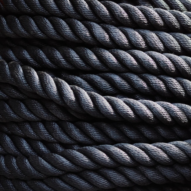 A close up of a black rope with a dark background