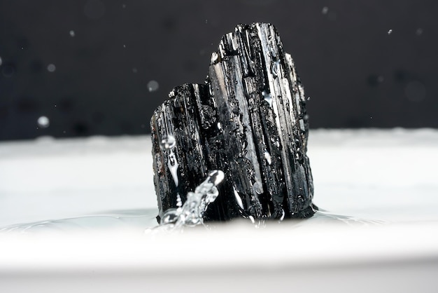 Photo close-up of black tourmaline mineral  on a background with bokeh lights