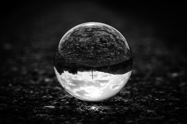 Close up black and white image of a lens ball