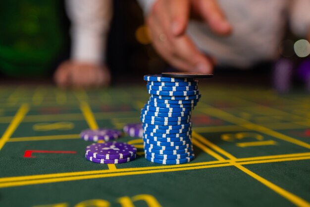 A close up of a blackjack dealer's hands in a casino, very shallow depth of field.