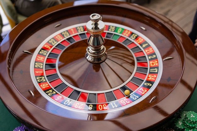 A close up of a blackjack dealer's hands in a casino, very shallow depth of field.