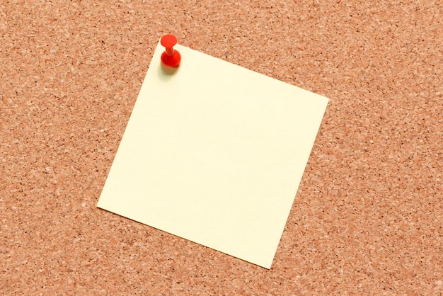 Close-up of blank adhesive note on bulletin board