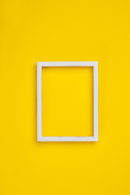 Photo close-up of blank picture frame on yellow wall