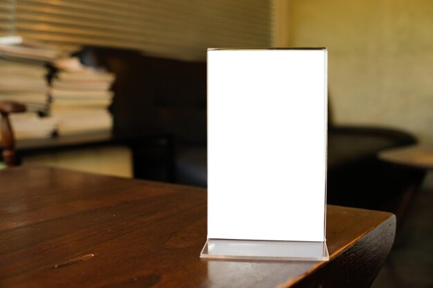 Photo close-up of blank placard on desk at office