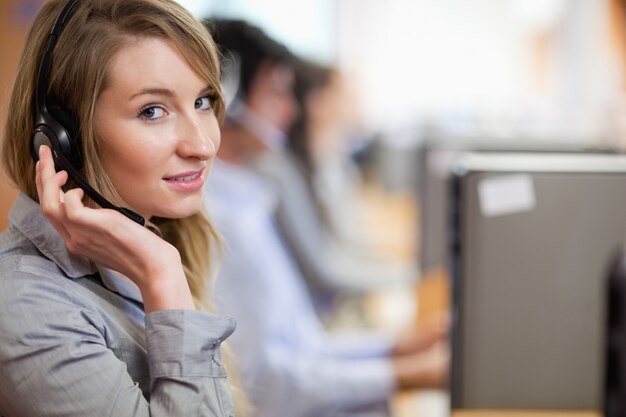 Close up of a blonde operator posing with a headset