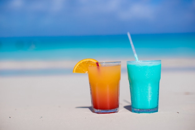 Close up Blue Curacao and Mango cocktail on the white sandy beach