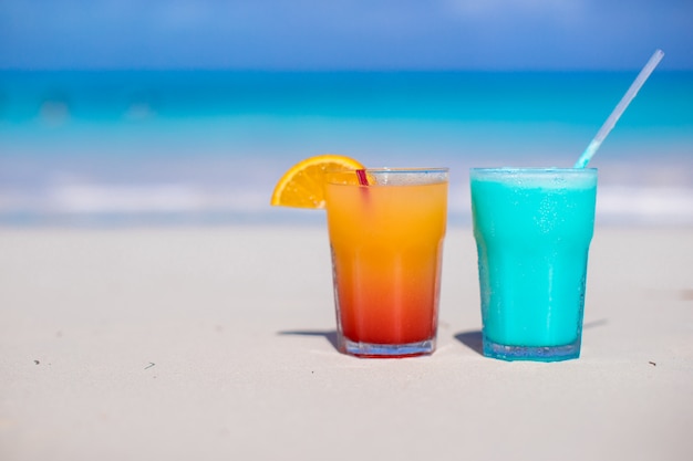 Close up Blue Curacao and Mango cocktail on the white sandy beach