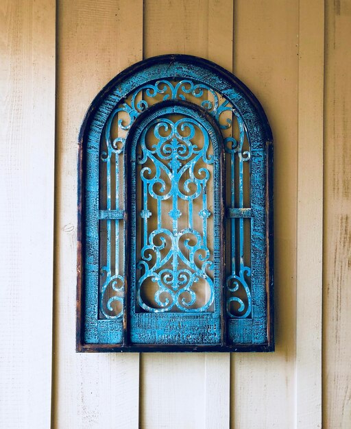 Close-up of blue metal art on building wall