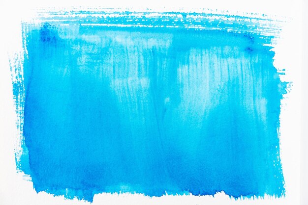 Photo close-up of blue paint over white background