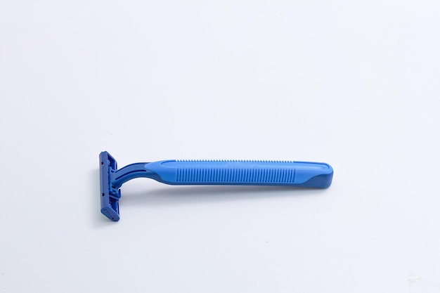 Close-up of blue razor against white background