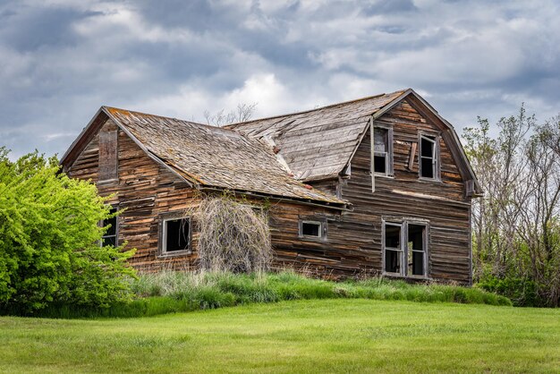 サスカチュワン州の大草原にある風格のある古い放棄された家の上の青い空のクローズアップ