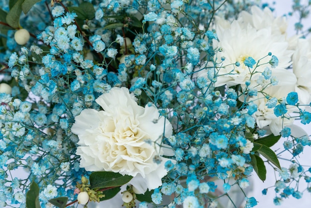 Close up of blue and white gypsophila in a bouquet flowers composition romantic selective focus