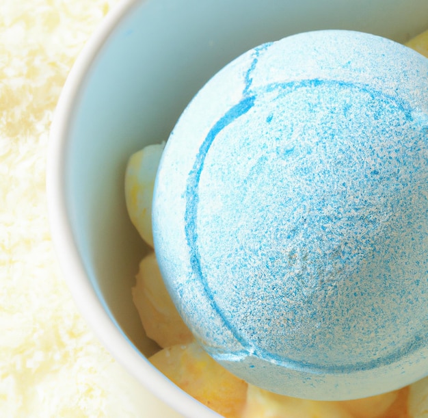 Close up of blue and yellow bath bombs in bowl